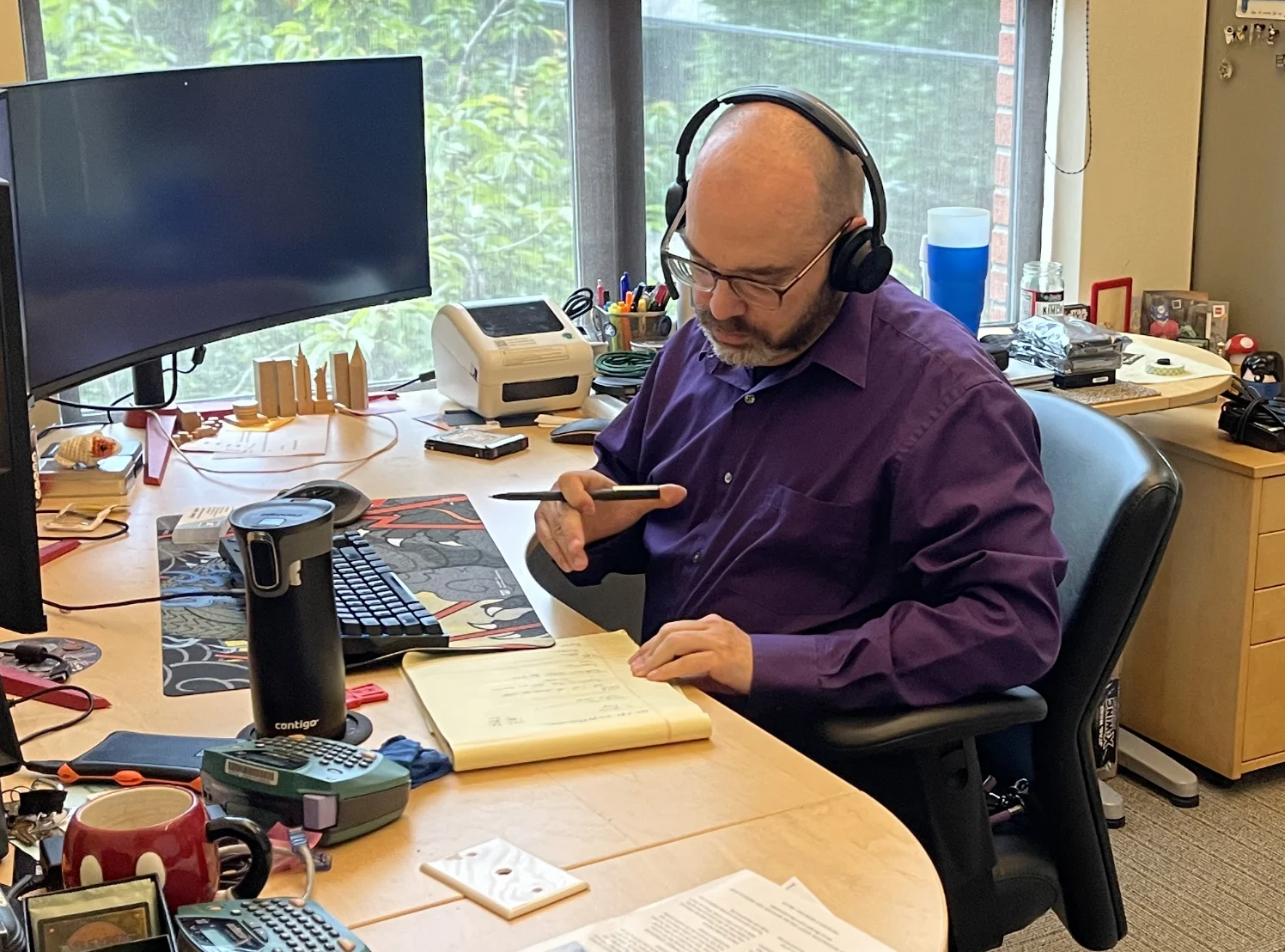 Photo of Adam working at his desk